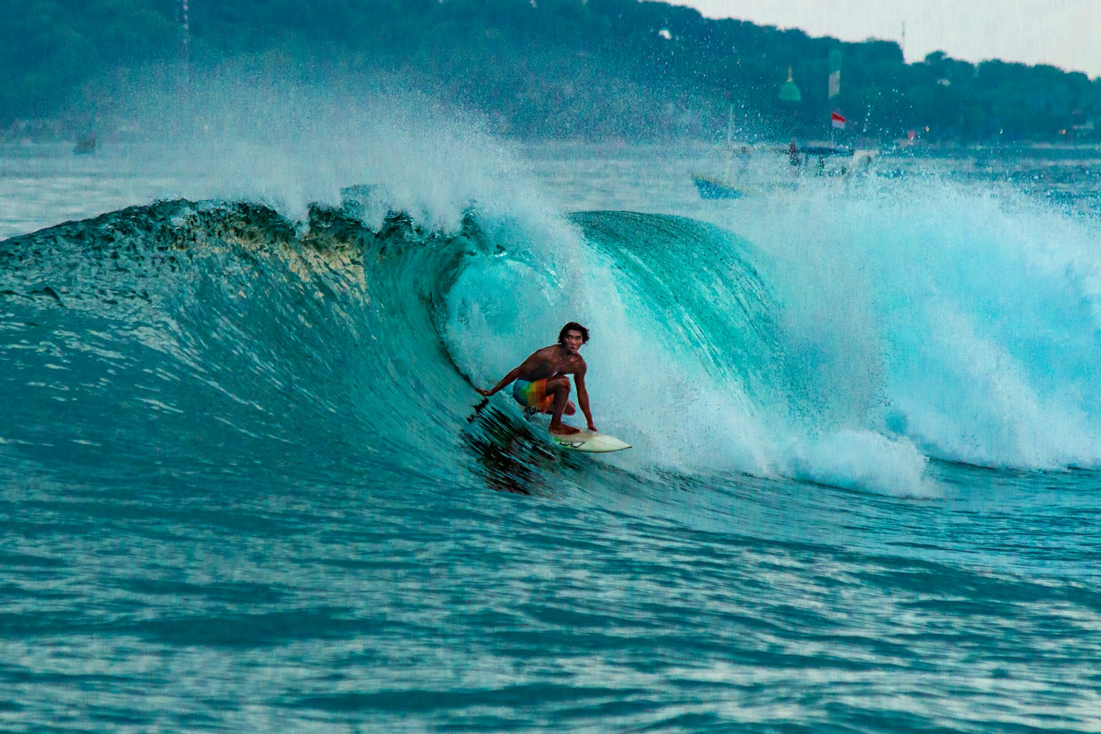 Surfer riding inside a barrel wave at a Bali reef break