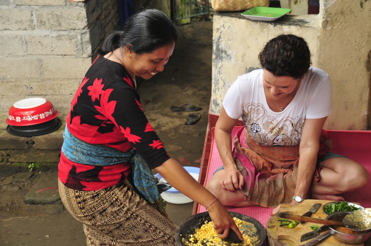 Cooking class participants preparing traditional Balinese dishes, Bali, Indonesia