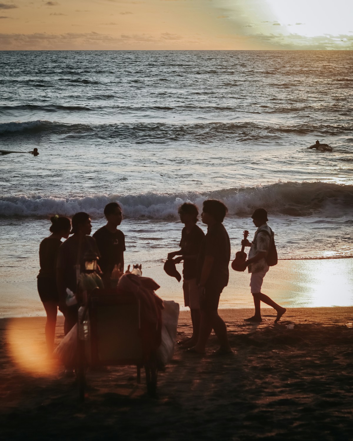 People on a Bali beach at sunset, Indonesia