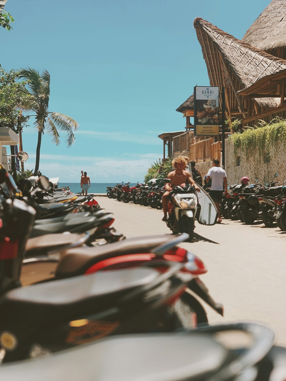 Parked motorcycles near Berawa Beach in the Canggu area, Bali, Indonesia