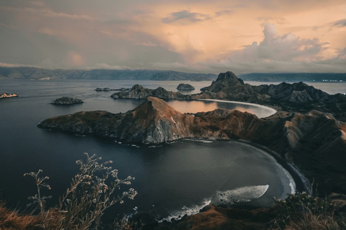 Rocky volcanic islands in a calm bay at sunset, East Nusa Tenggara, Indonesia