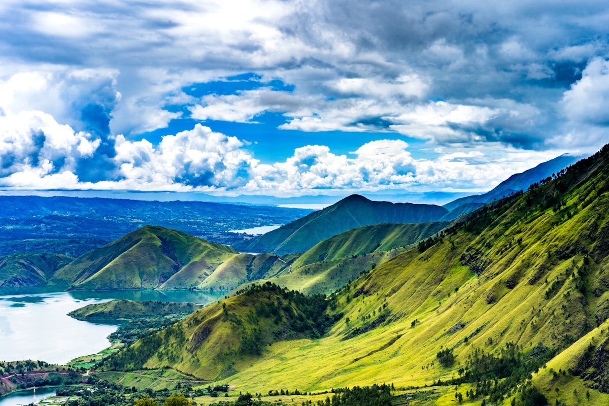 Highland valley with Lake Toba visible in the distance, North Sumatra, Indonesia
