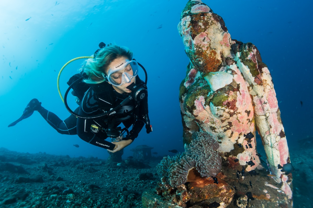 Woman scuba diving in clear water, Bali, Indonesia