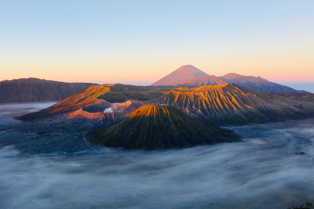 Mount Bromo caldera at sunrise with Mount Semeru behind, East Java