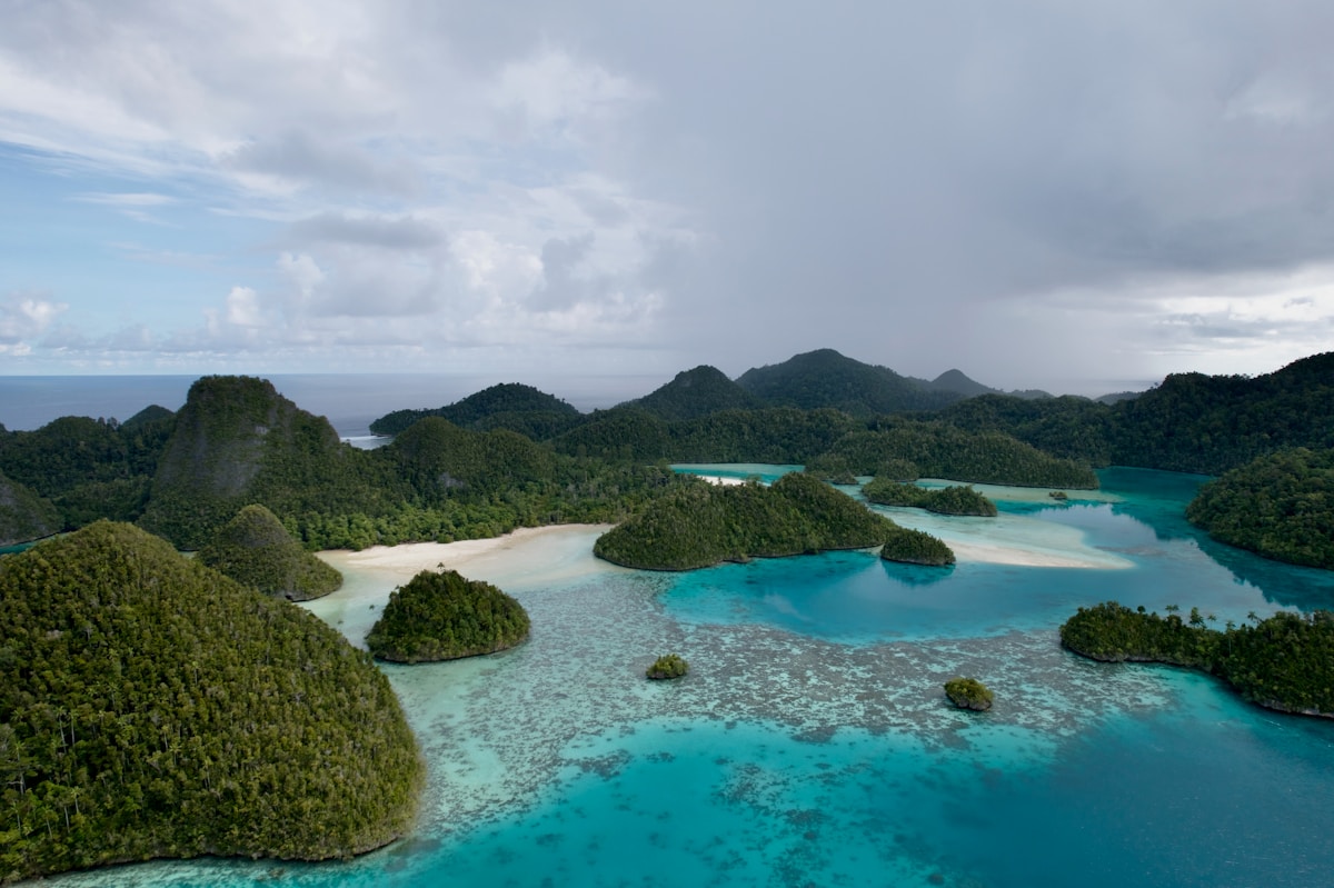 Islands dotting a turquoise sea beneath cloudy skies, Eastern Indonesia