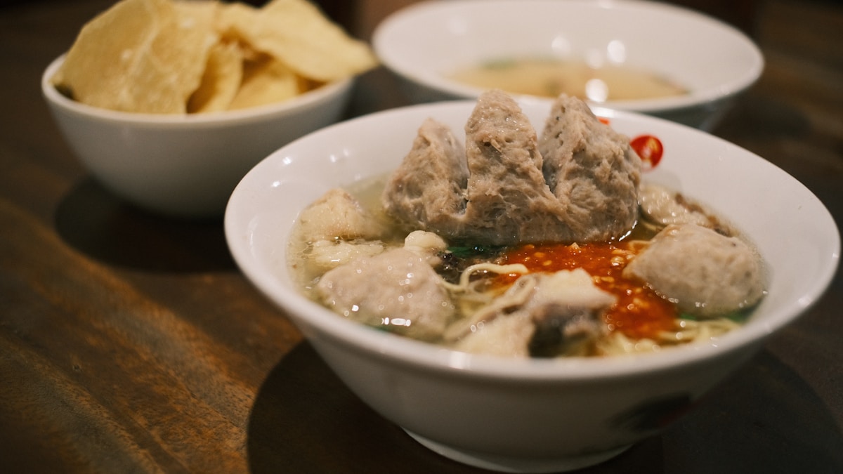 Bowl of meatball noodle soup with chilli sauce, Jakarta, Indonesia