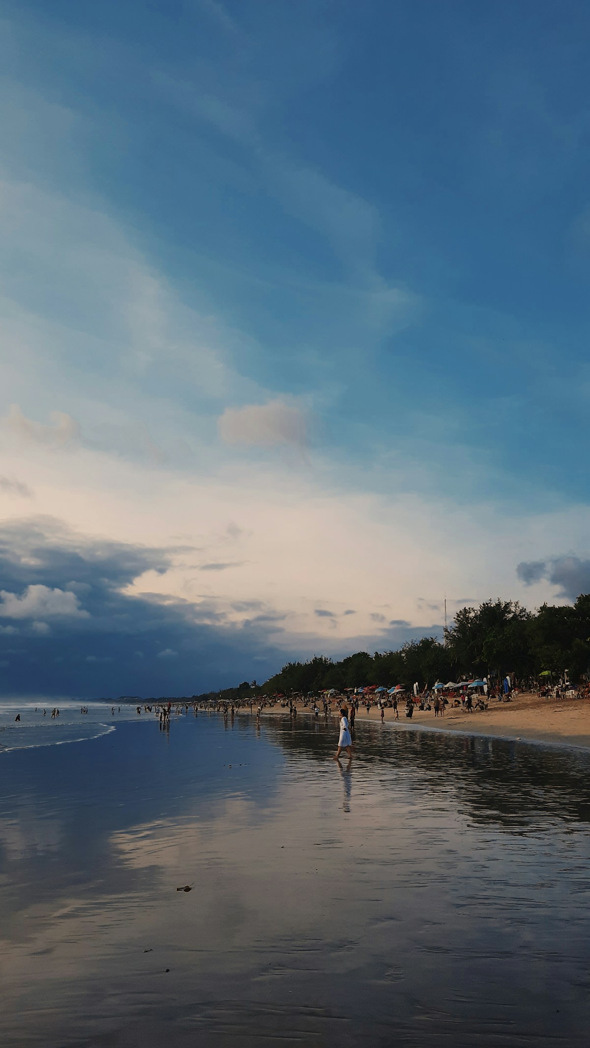 Beach with people and trees, Kuta, Bali, Indonesia