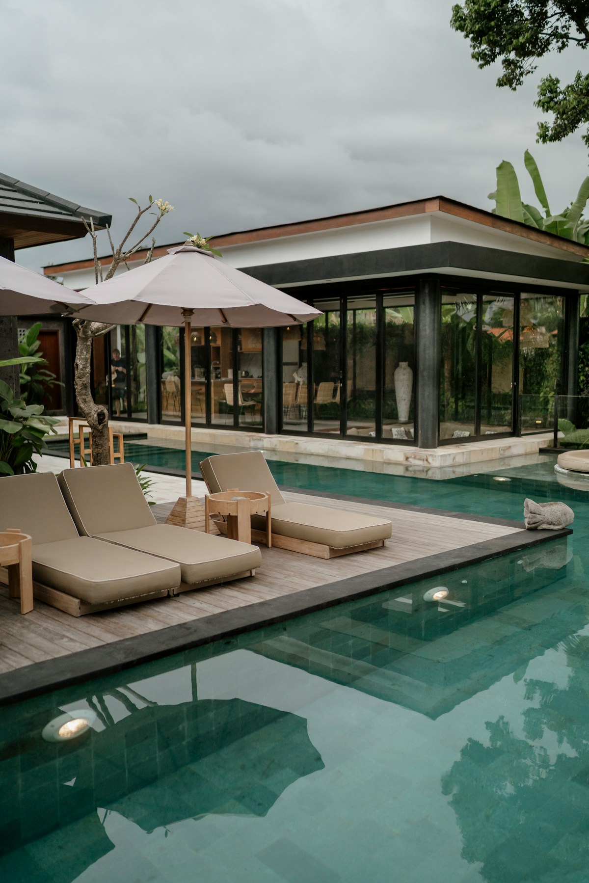 Hotel pool and gardens in Medan, North Sumatra with palm trees at dusk