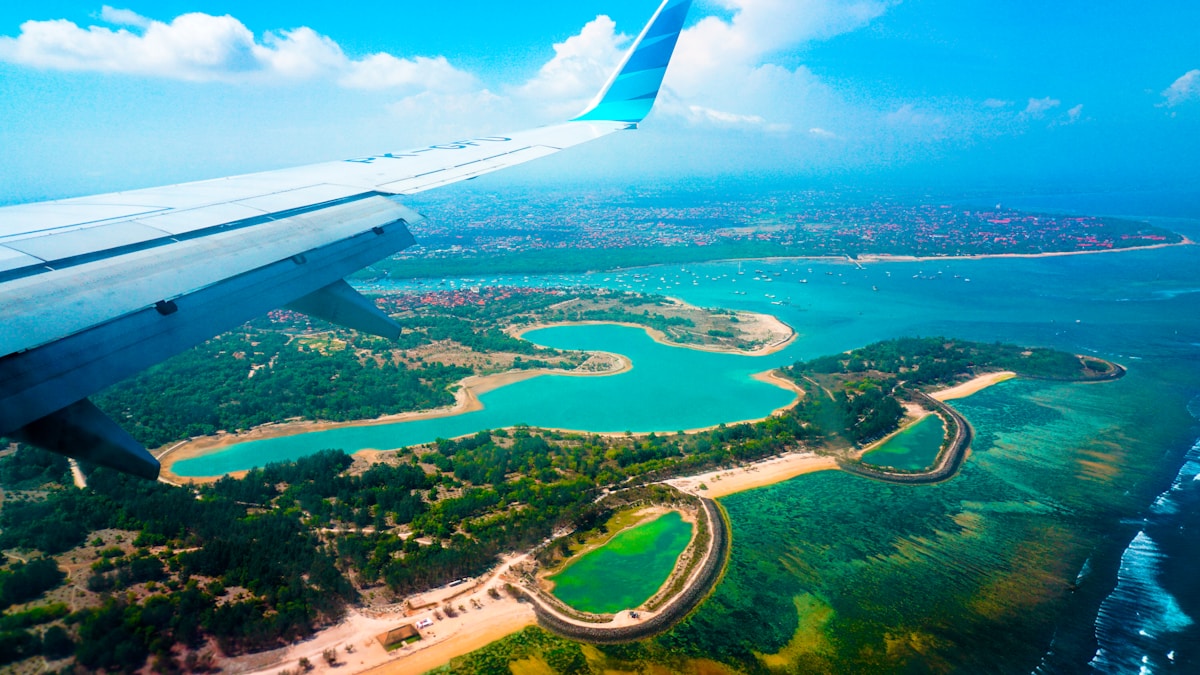 Person inside airplane with view of island, Indonesia