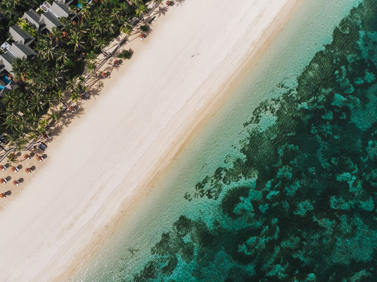 Aerial view of Nusa Dua Beach with calm water and beach umbrellas, Bali, Indonesia