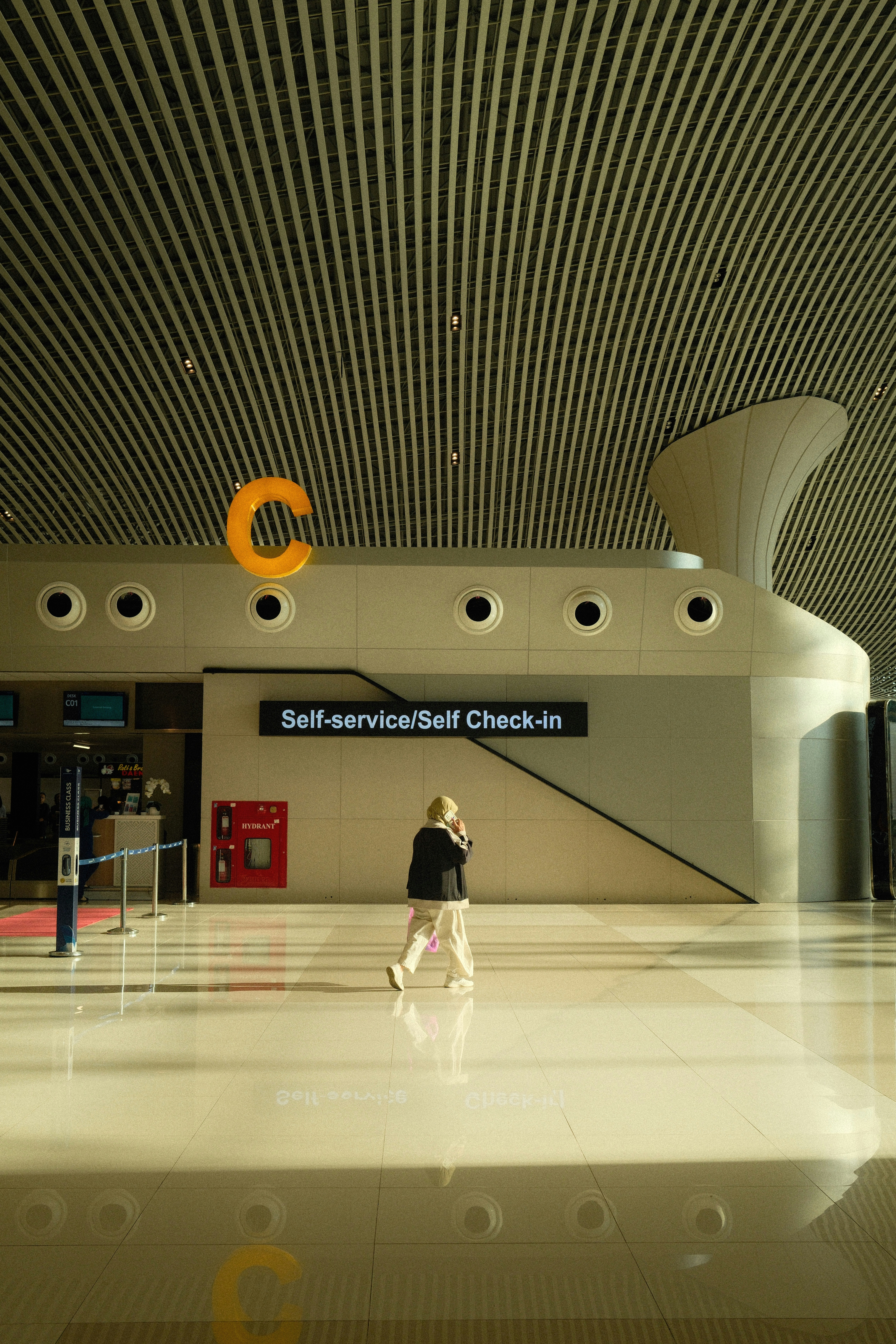 Traveller walking through a modern Indonesian airport terminal