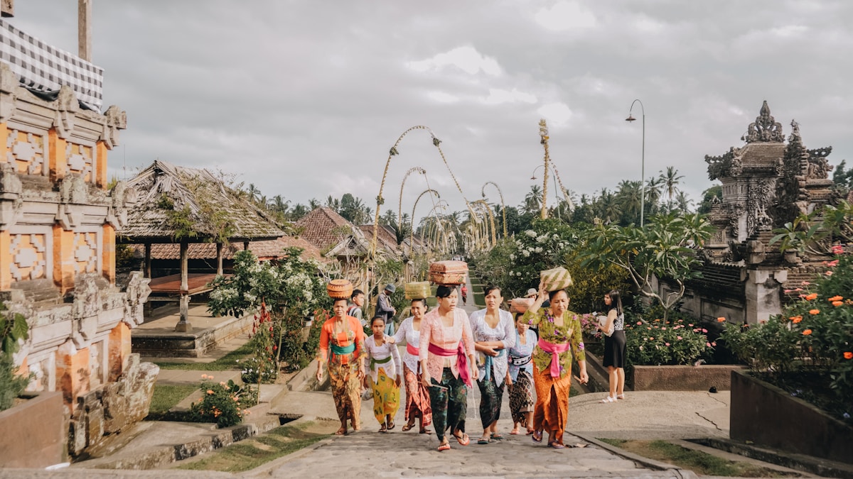 Women walking together on a lush park path, Bali, Indonesia