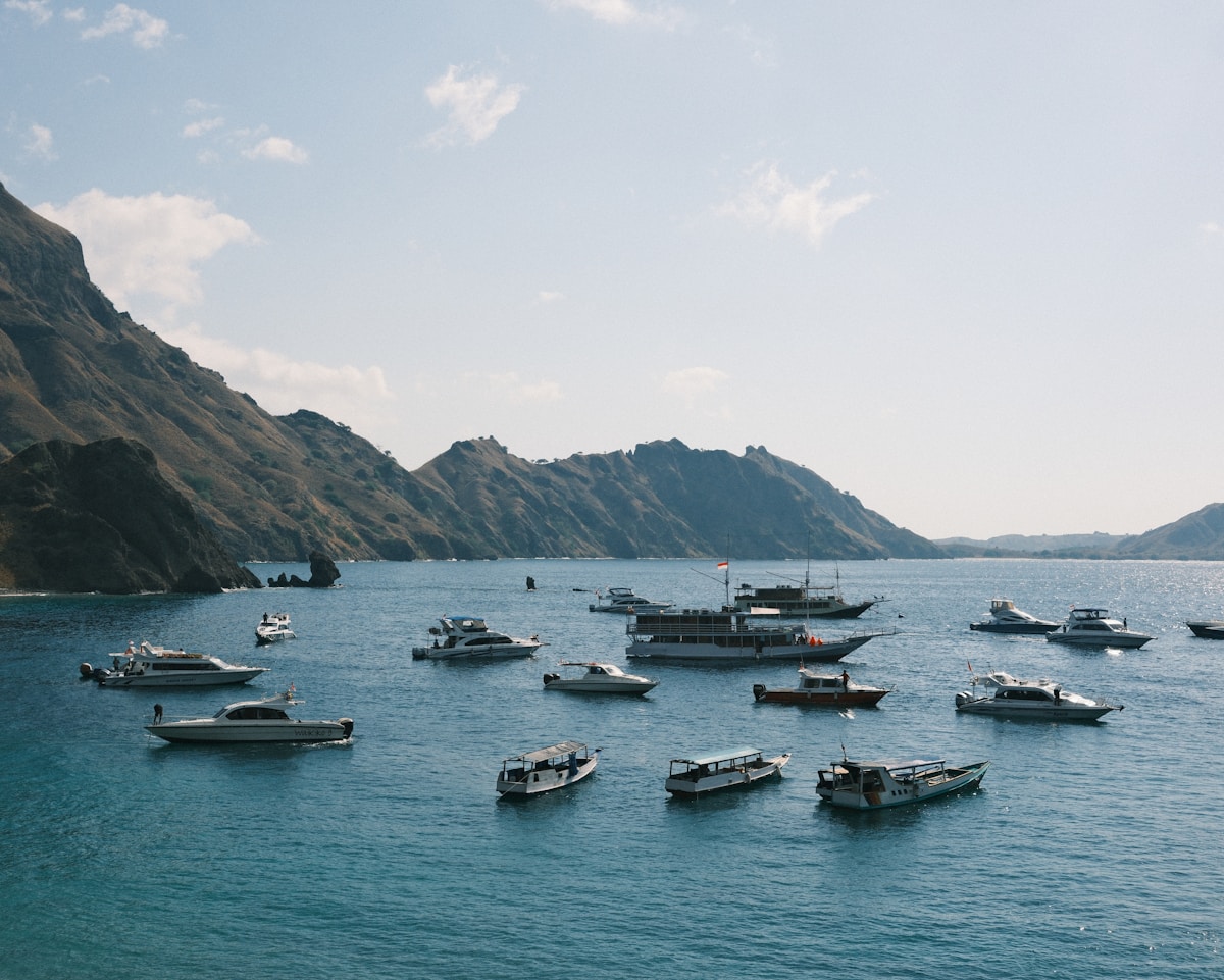 Boats anchored in turquoise water at Padar Island, Flores, Indonesia