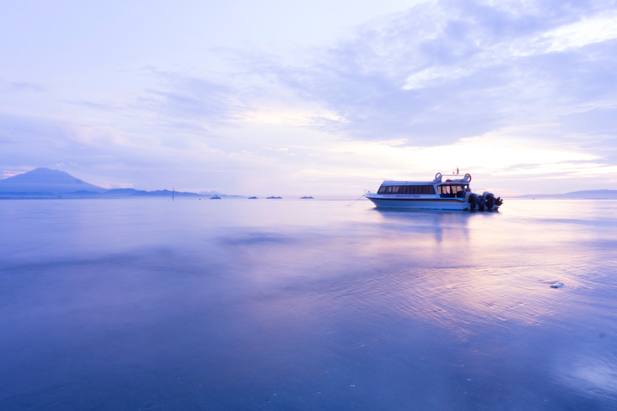 Fast boat on calm water at dusk, Bali, Indonesia