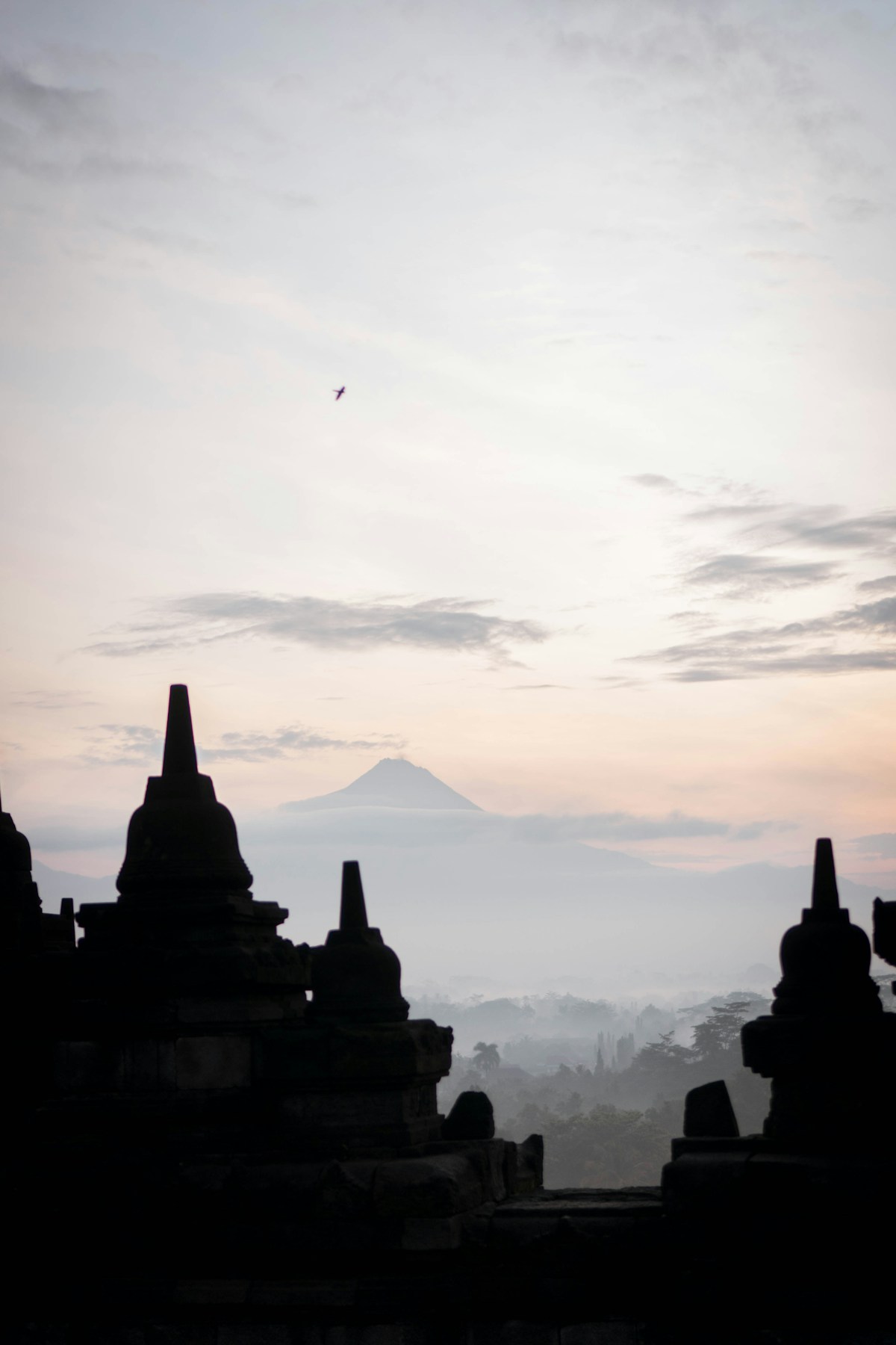 Borobudur temple silhouette at sunrise with volcano, Central Java, Indonesia