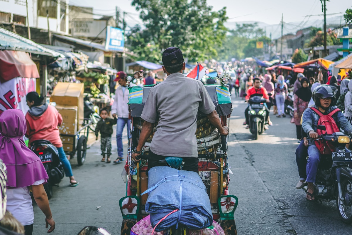 Man pedaling a wagon on a street, Bandung City, Indonesia