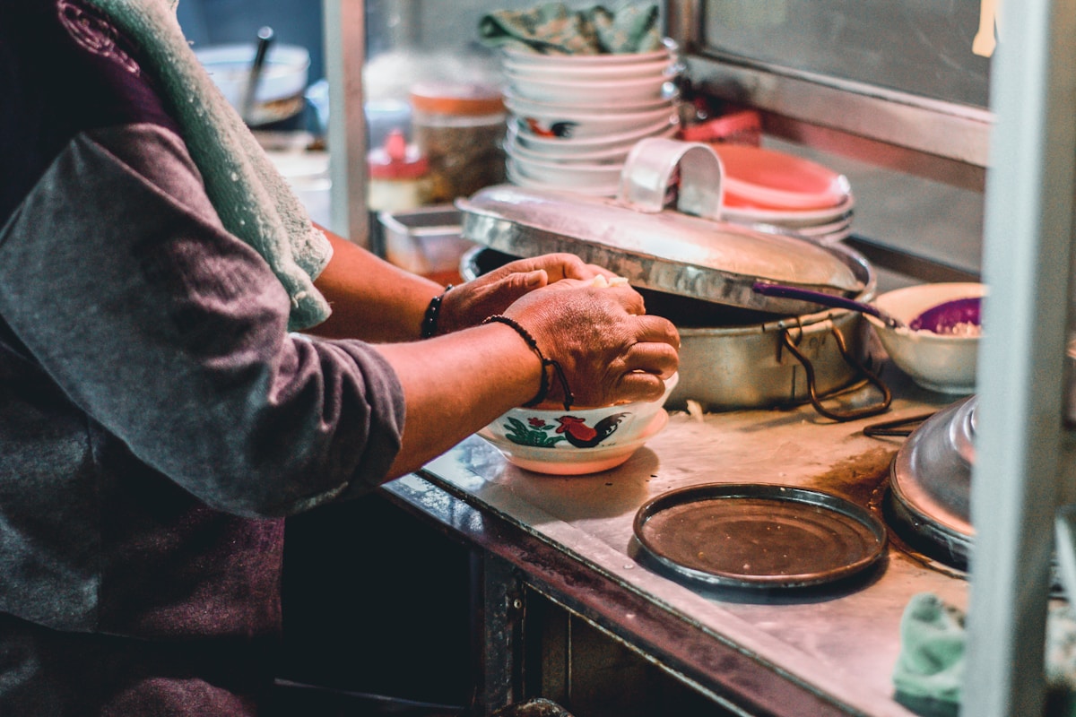 Person holding bowl of Indonesian food, Indonesia
