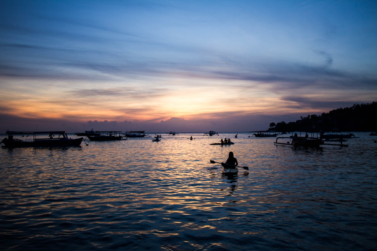 Person rowing a boat off Senggigi beach, West Lombok, Indonesia
