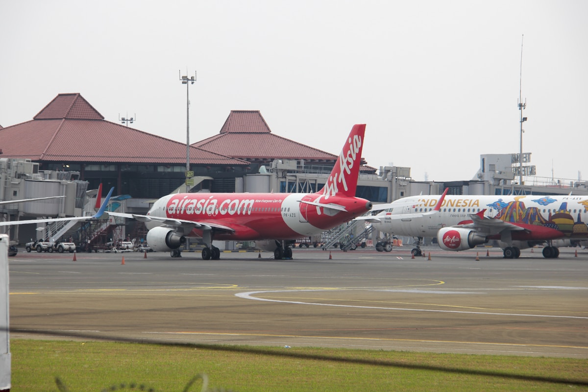Two airplanes on the runway at Soekarno-Hatta International Airport, Jakarta, Indonesia