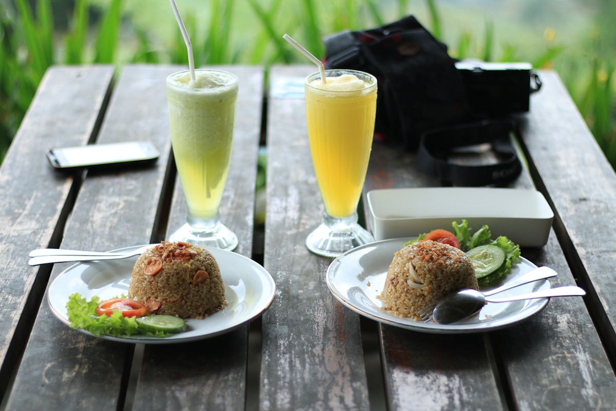 Fried rice and fresh juice on a wooden table, Ubud area, Bali, Indonesia
