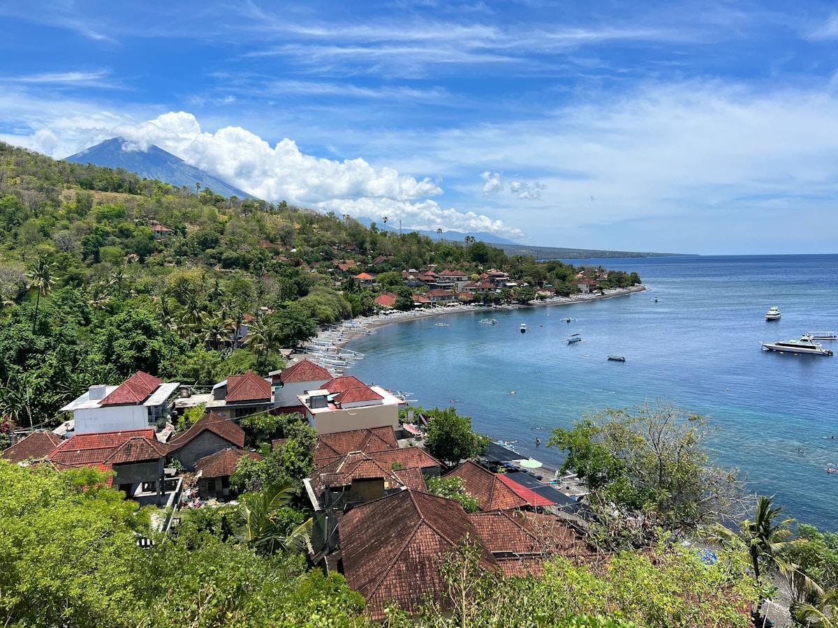 Coastal village with black sand beach and Mount Agung volcano in the background, Amed, Bali