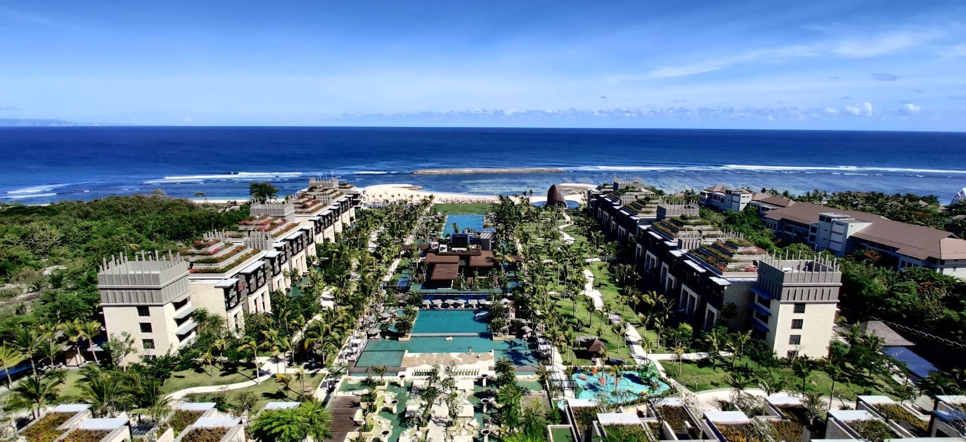 Aerial view of luxury resort complex with pools facing the ocean, Nusa Dua, Bali